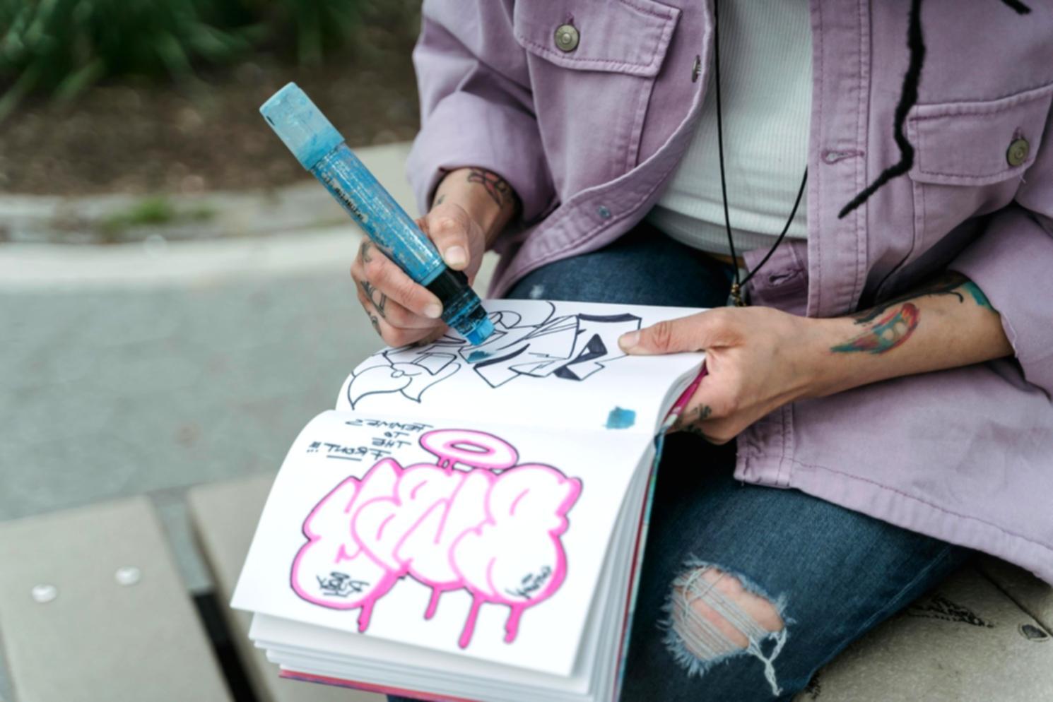 Art instructor demonstrating portrait techniques to students in classroom setting